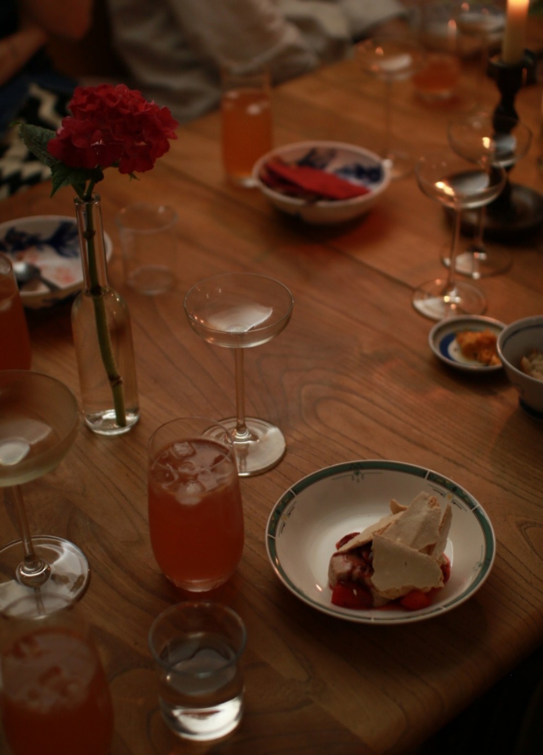 Candlelit table with cocktails and a small dessert